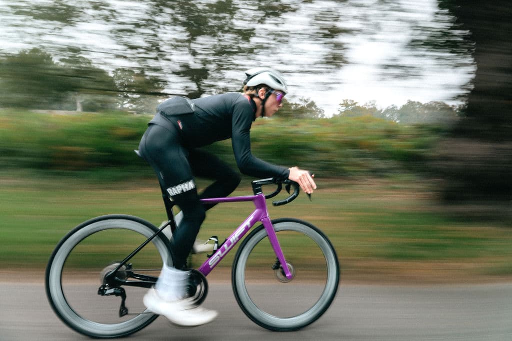 Purple SWIFT bike at speed with motion blur in the park